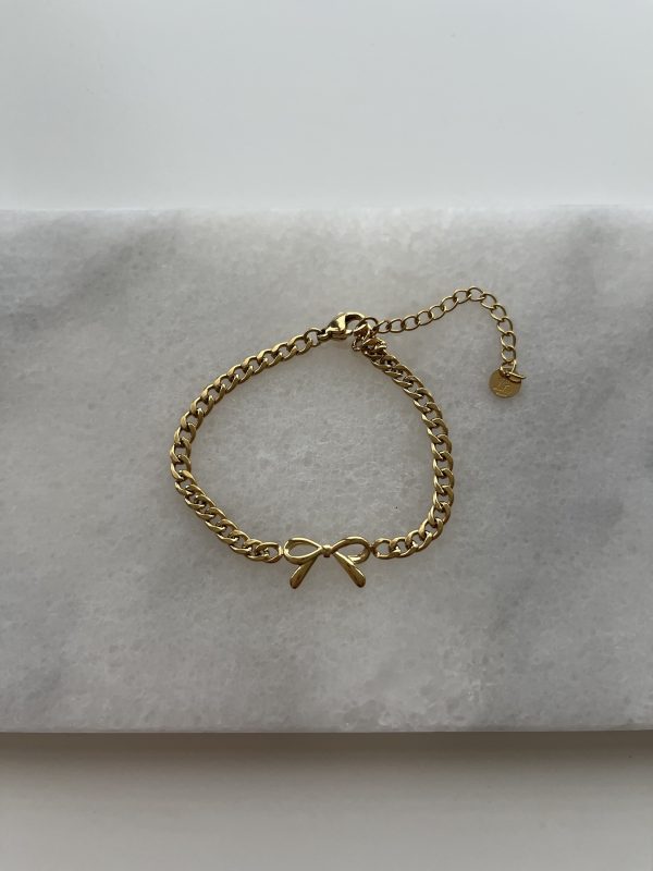 Goudkleurige schakelarmband met strikje. Stainless steel.
